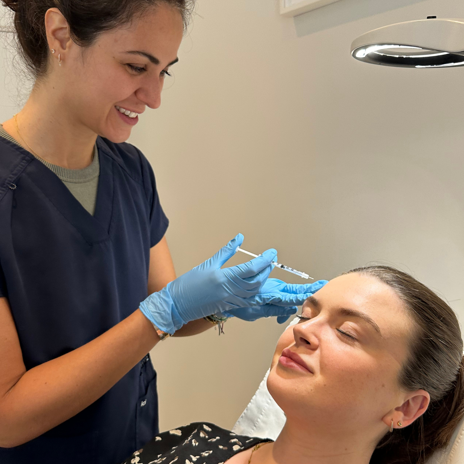 Dr Sepi with a client delivering Wrinle Relaxing Treatments in Medicetics Central London Aesthetic Clinic